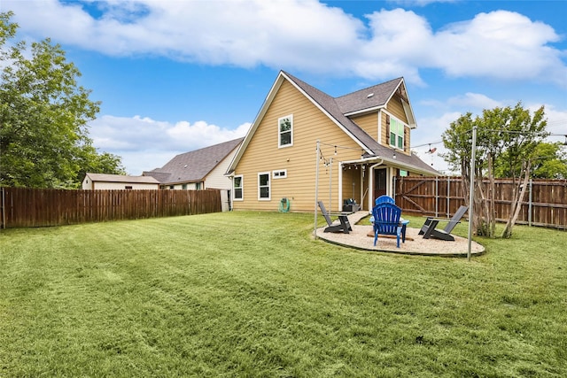 back of house featuring a fenced backyard, a shingled roof, a patio area, and a lawn