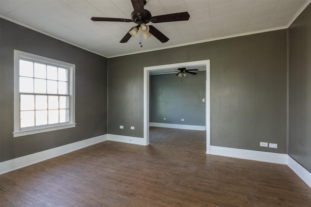 unfurnished room featuring a ceiling fan, crown molding, baseboards, and dark wood-style flooring