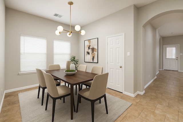 9212 Water Oak Dr, Arlington, TX 76002 - dining space with arched walkways, baseboards, light tile patterned floors, and a chandelier