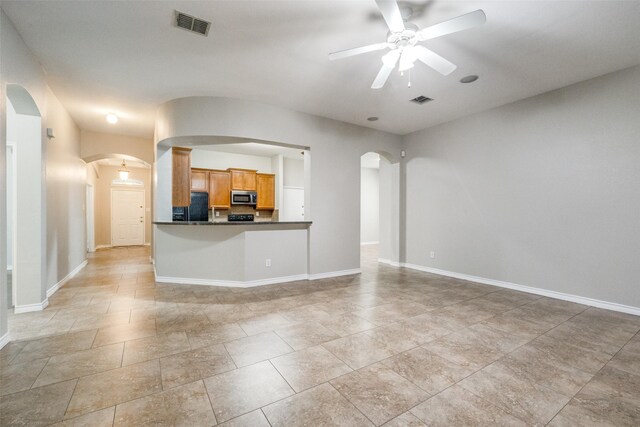 9212 Water Oak Dr, Arlington, TX 76002 - unfurnished living room with arched walkways, a ceiling fan, and baseboards