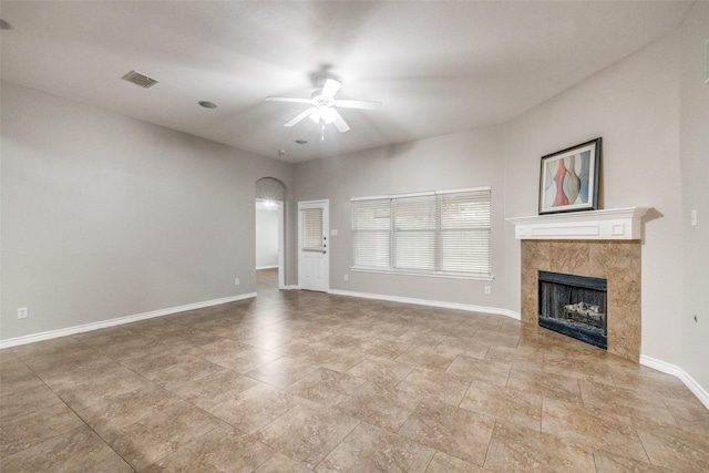 9212 Water Oak Dr, Arlington, TX 76002 - unfurnished living room featuring a ceiling fan, a fireplace, baseboards, and arched walkways