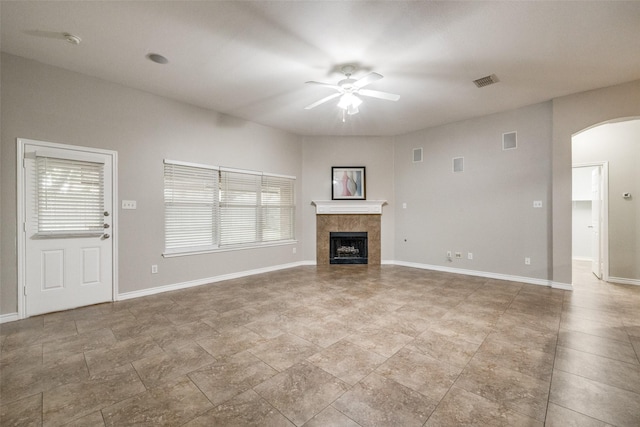 9212 Water Oak Dr, Arlington, TX 76002 - unfurnished living room with a ceiling fan, arched walkways, healthy amount of natural light, and a tiled fireplace