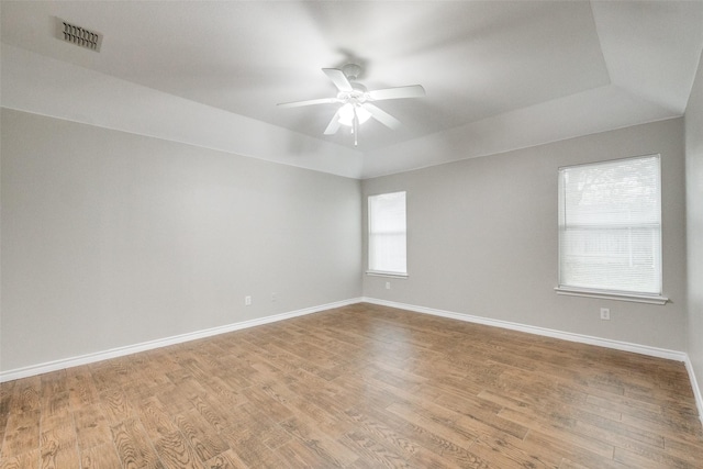 9212 Water Oak Dr, Arlington, TX 76002 - empty room with ceiling fan, wood finished floors, baseboards, and a tray ceiling