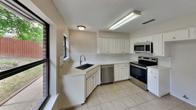 kitchen featuring visible vents, light countertops, a sink, and appliances with stainless steel finishes