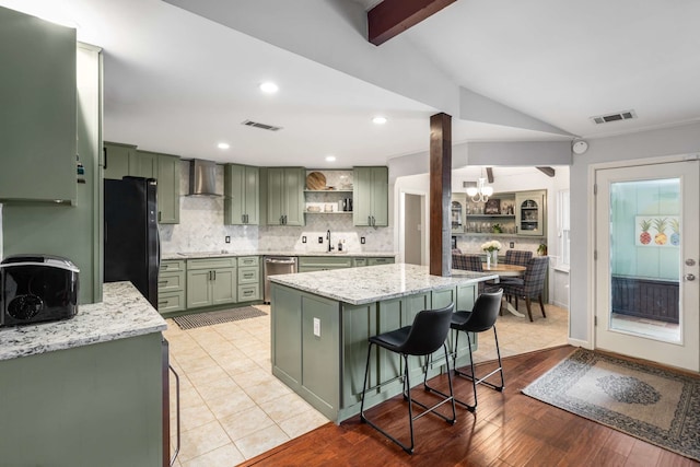 1417 Northridge Dr, Carrollton, TX 75006 - kitchen with visible vents, green cabinetry, wall chimney exhaust hood, and black appliances