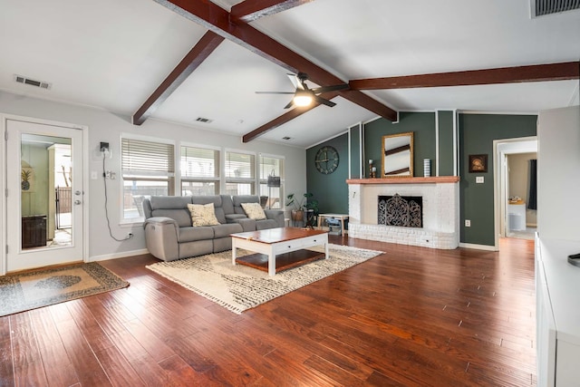 1417 Northridge Dr, Carrollton, TX 75006 - living room with visible vents, a brick fireplace, wood finished floors, vaulted ceiling with beams, and a ceiling fan