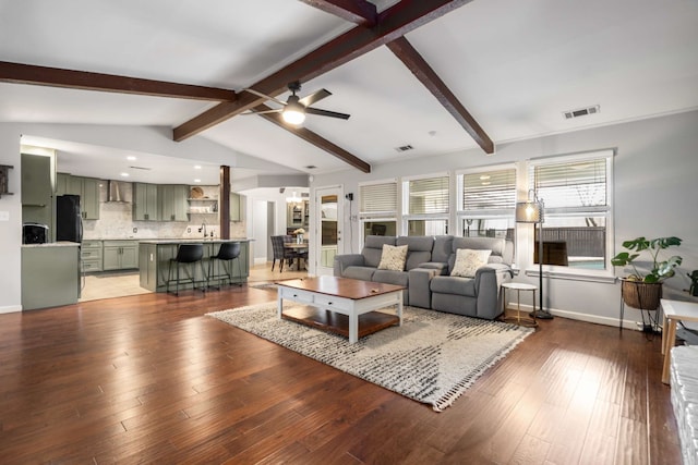 1417 Northridge Dr, Carrollton, TX 75006 - living room with visible vents, baseboards, vaulted ceiling with beams, a ceiling fan, and light wood-style flooring