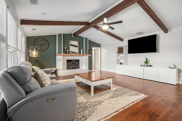 1417 Northridge Dr, Carrollton, TX 75006 - living area with ceiling fan, visible vents, a fireplace, wood finished floors, and lofted ceiling with beams