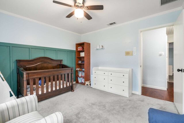 1417 Northridge Dr, Carrollton, TX 75006 - carpeted bedroom featuring crown molding, a nursery area, ceiling fan, and visible vents