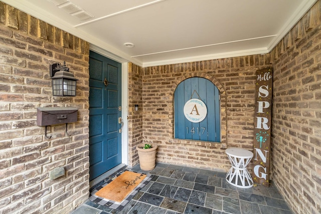 1417 Northridge Dr, Carrollton, TX 75006 - property entrance featuring a porch, brick siding, and visible vents