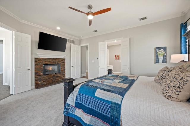 bedroom featuring a stone fireplace, visible vents, carpet floors, and ornamental molding