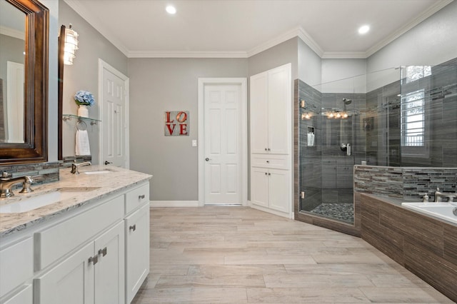 bathroom featuring wood finished floors, ornamental molding, a shower stall, a sink, and a bath