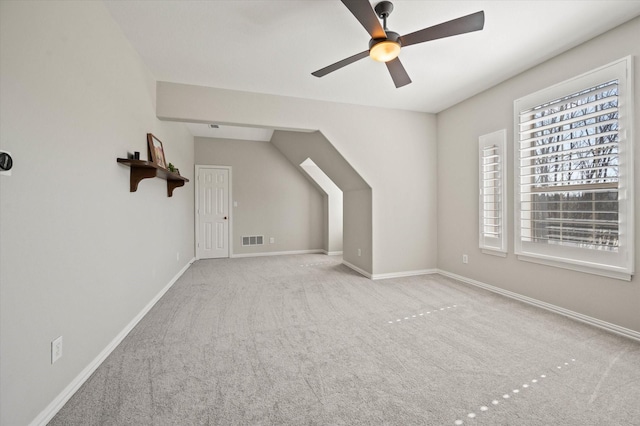 bonus room with carpet floors, baseboards, visible vents, and ceiling fan