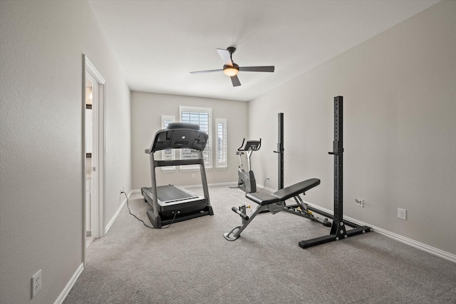 exercise room featuring carpet floors, baseboards, and ceiling fan