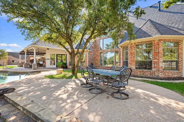 view of patio with outdoor dining area, an outdoor pool, and a ceiling fan