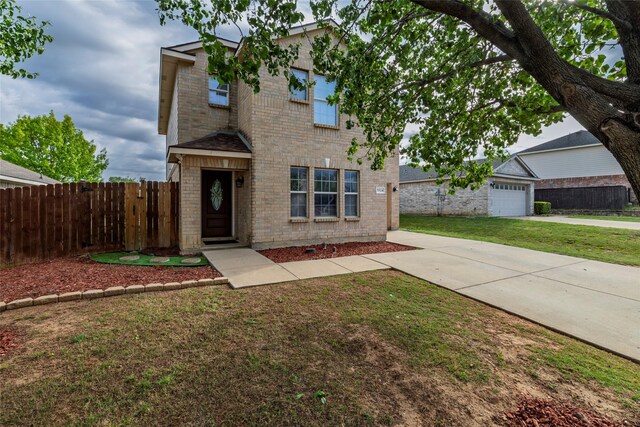 traditional-style house featuring a front lawn, driveway, fence, and brick siding
