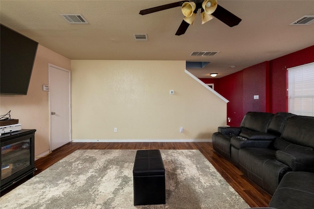 living area featuring wood finished floors, ceiling fan, and visible vents