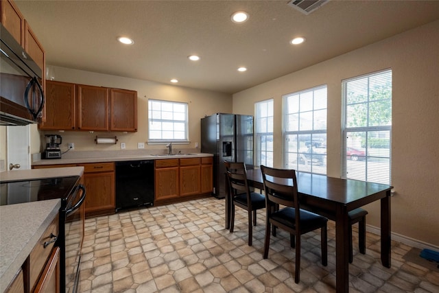 kitchen featuring a sink, visible vents, light countertops, and black appliances