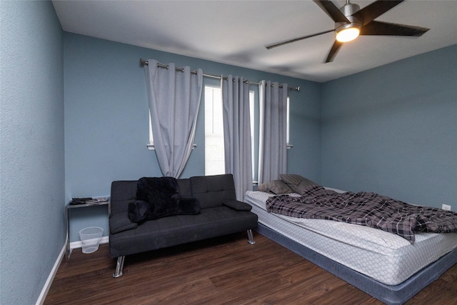 bedroom with baseboards, wood finished floors, and a ceiling fan