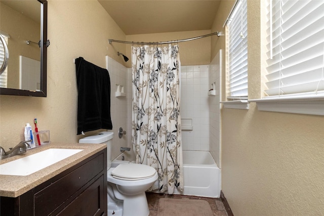 full bath featuring toilet, vanity, a textured wall, and shower / tub combo with curtain
