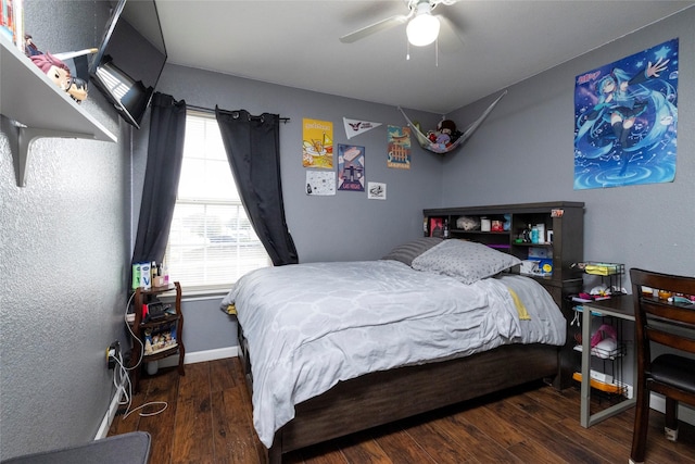 bedroom with baseboards, wood finished floors, and a ceiling fan