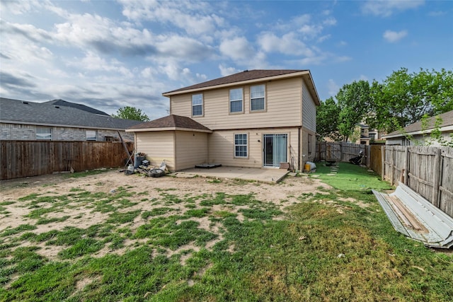 back of house featuring a fenced backyard, a patio, and a yard