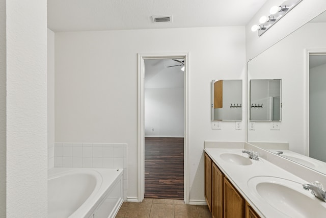 1416 Eagles Nest Trl, Krum, TX 76249 - bathroom featuring double vanity, a garden tub, tile patterned flooring, and baseboards