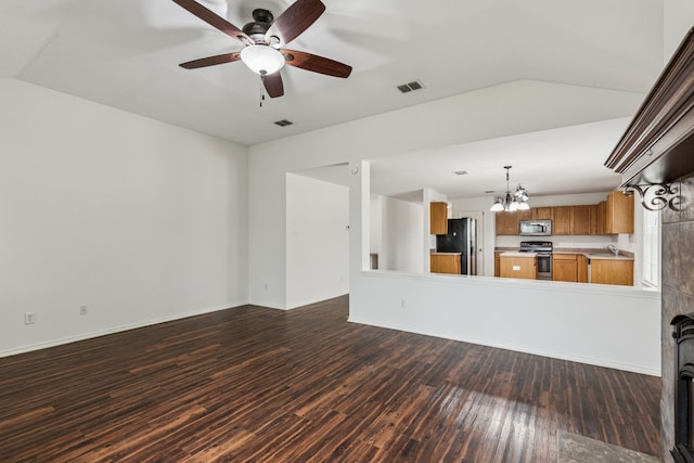 1416 Eagles Nest Trl, Krum, TX 76249 - unfurnished living room featuring a sink, a chandelier, dark wood finished floors, a ceiling fan, and baseboards