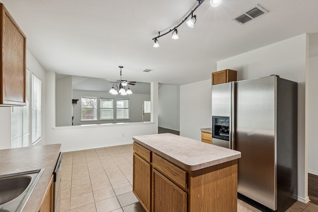 1416 Eagles Nest Trl, Krum, TX 76249 - kitchen with stainless steel fridge with ice dispenser, a chandelier, a center island, and brown cabinets