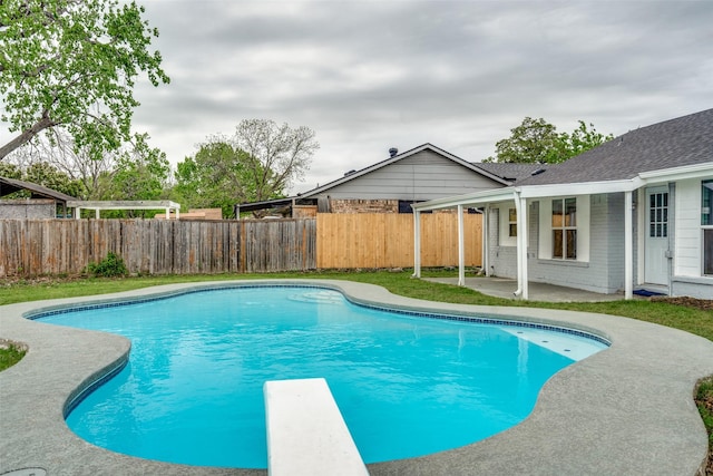 2828 Elk Grove Rd, Carrollton, TX 75007 - view of swimming pool with a patio area, a fenced backyard, and a diving board