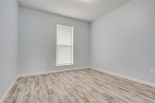 2828 Elk Grove Rd, Carrollton, TX 75007 - spare room featuring wood finished floors and baseboards