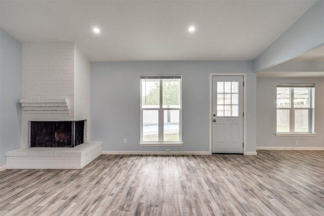 2828 Elk Grove Rd, Carrollton, TX 75007 - unfurnished living room featuring a brick fireplace, wood finished floors, baseboards, and recessed lighting