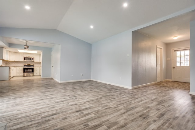 2828 Elk Grove Rd, Carrollton, TX 75007 - unfurnished living room featuring light wood-style floors, vaulted ceiling, baseboards, recessed lighting, and a sink
