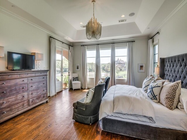 bedroom featuring visible vents, a raised ceiling, a chandelier, access to outside, and dark wood-type flooring