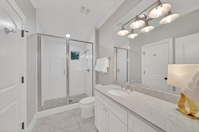 bathroom featuring vanity, marble finish floor, a stall shower, and toilet
