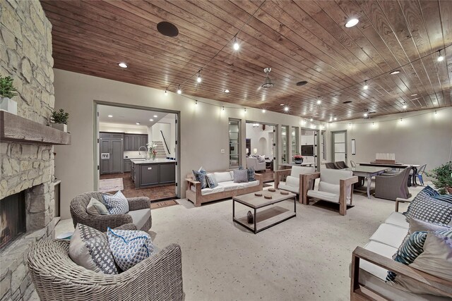 living area featuring recessed lighting, wood ceiling, and a fireplace