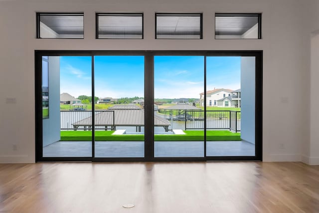12479 Palmer Dr, Fort Worth, TX 76179 - entryway with wood finished floors, a water view, a residential view, and baseboards