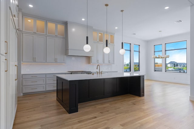 12479 Palmer Dr, Fort Worth, TX 76179 - kitchen featuring light wood-style floors, light countertops, a sink, an island with sink, and recessed lighting