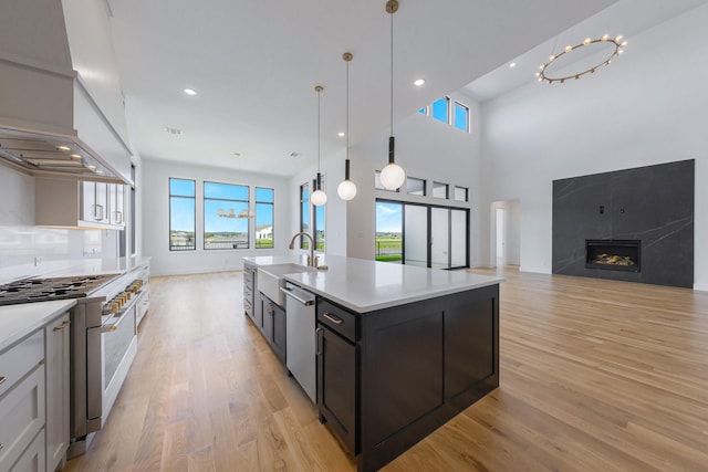 12479 Palmer Dr, Fort Worth, TX 76179 - kitchen featuring double oven range, dishwasher, open floor plan, a sink, and light countertops