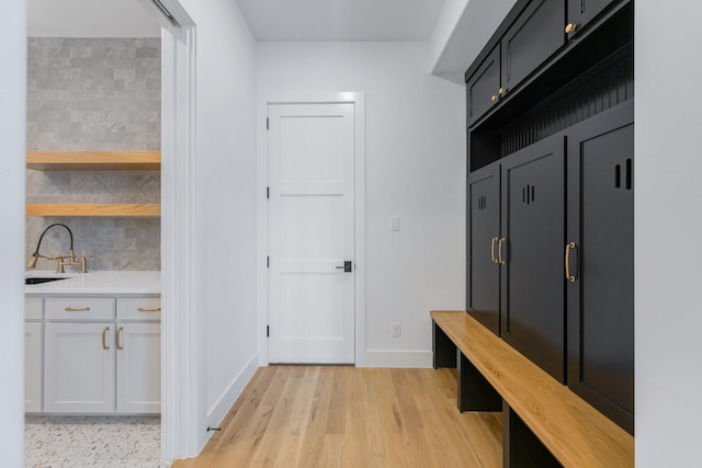 12479 Palmer Dr, Fort Worth, TX 76179 - mudroom featuring a sink, light wood-style floors, and baseboards
