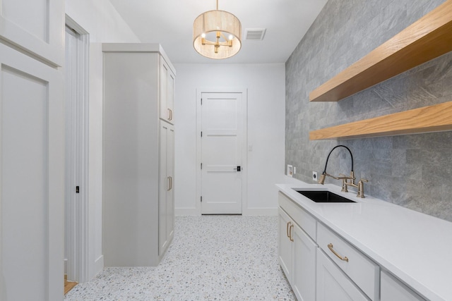 12479 Palmer Dr, Fort Worth, TX 76179 - washroom with a sink, baseboards, and a chandelier