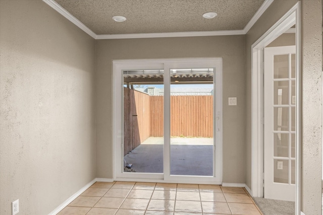 entryway with a textured ceiling, ornamental molding, a textured wall, and light tile patterned floors