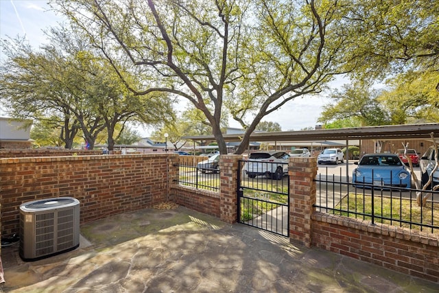 view of patio / terrace featuring central AC unit, a gate, and fence