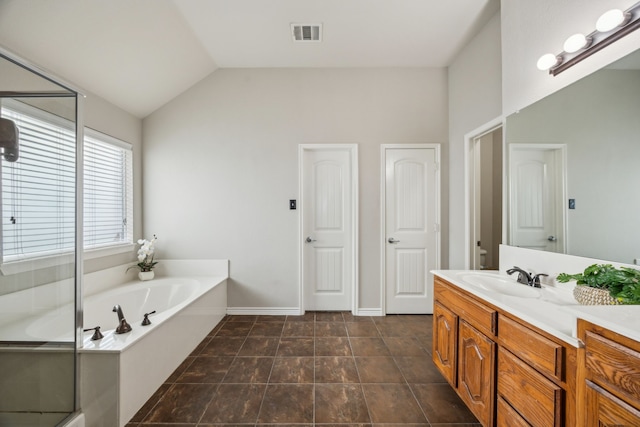 8312 Rancho De La Osa Trl, Mckinney, TX 75070 - full bath with vanity, a garden tub, a shower stall, lofted ceiling, and baseboards