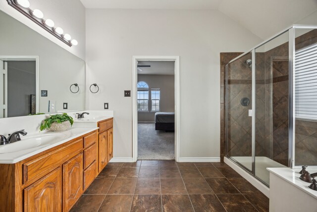 8312 Rancho De La Osa Trl, Mckinney, TX 75070 - ensuite bathroom with double vanity, a shower stall, baseboards, and lofted ceiling