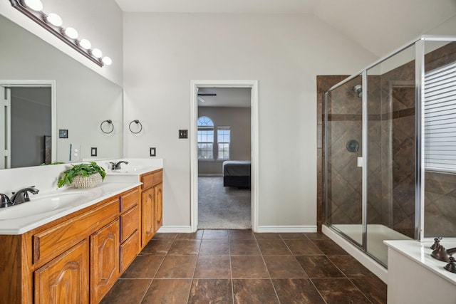8312 Rancho De La Osa Trl, Mckinney, TX 75070 - ensuite bathroom featuring double vanity, a shower stall, baseboards, and vaulted ceiling