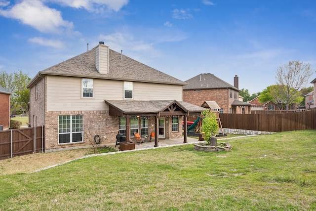 8312 Rancho De La Osa Trl, Mckinney, TX 75070 - back of property with a playground, a patio area, brick siding, and a chimney
