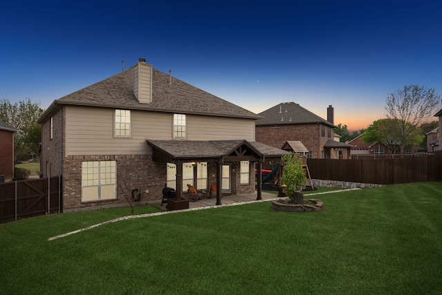 8312 Rancho De La Osa Trl, Mckinney, TX 75070 - rear view of property featuring a patio, a chimney, brick siding, and a playground