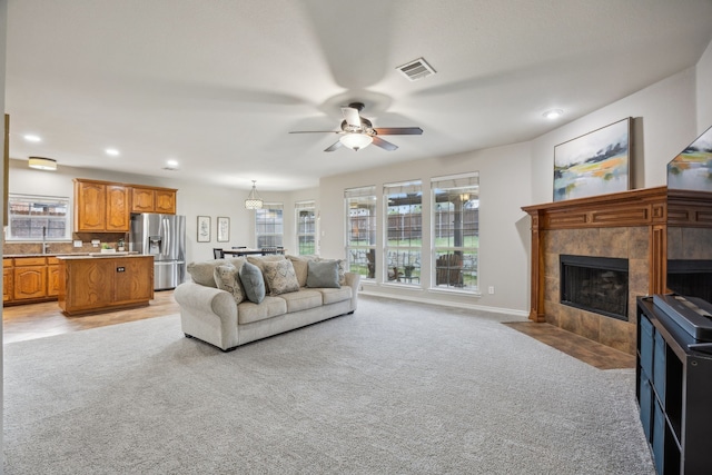 8312 Rancho De La Osa Trl, Mckinney, TX 75070 - living area featuring light carpet, ceiling fan, a fireplace, recessed lighting, and baseboards