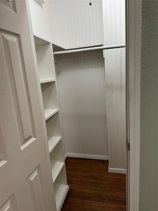spacious closet with dark wood-style flooring